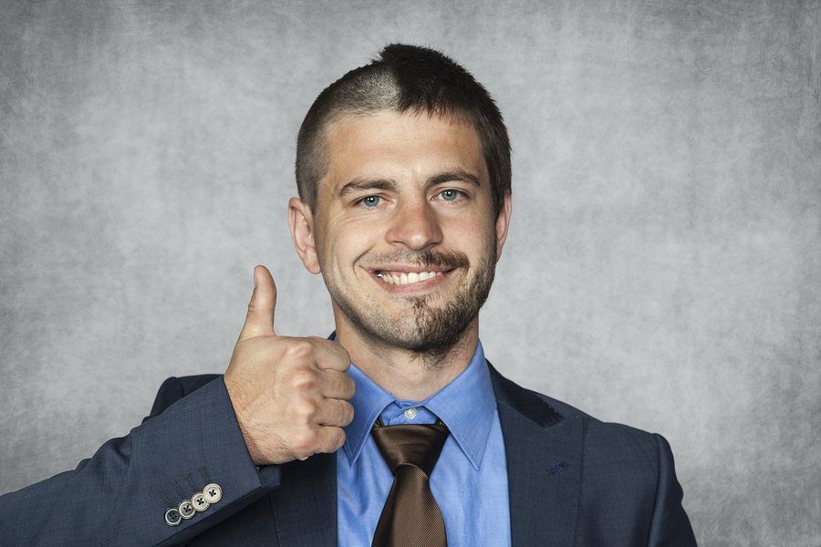 Man in a suit with an unusual haircut