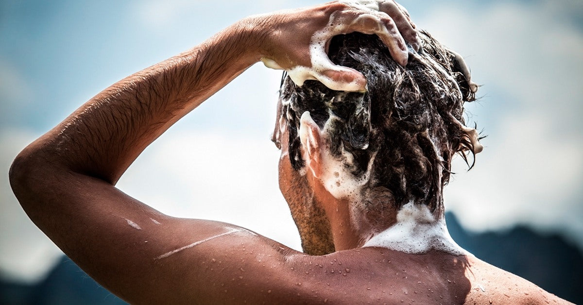 Man washing his hair with shampoo