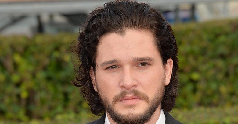 Kit Harington with curly hair and a beard